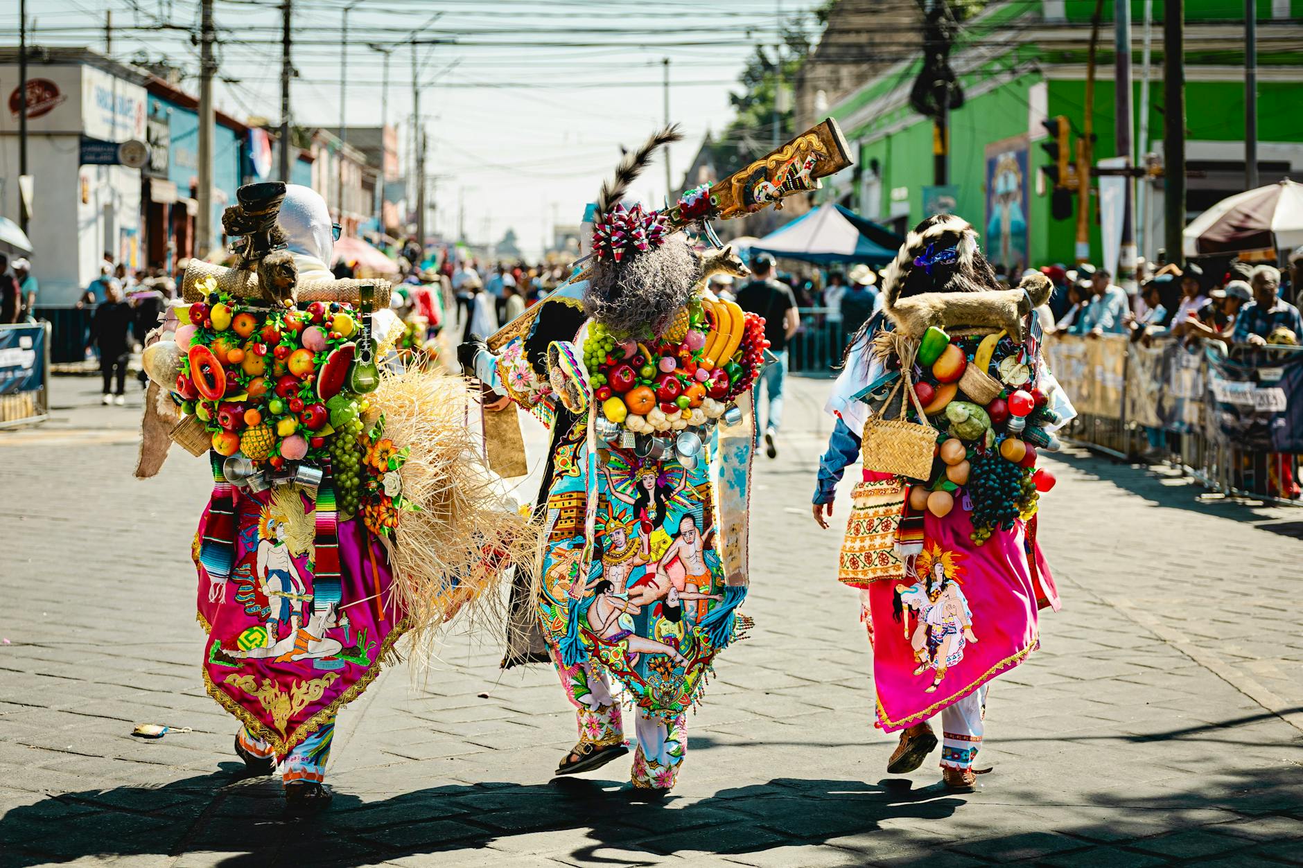 Colorful costumes in a vibrant festival parade in Huejotzingo, Mexico.